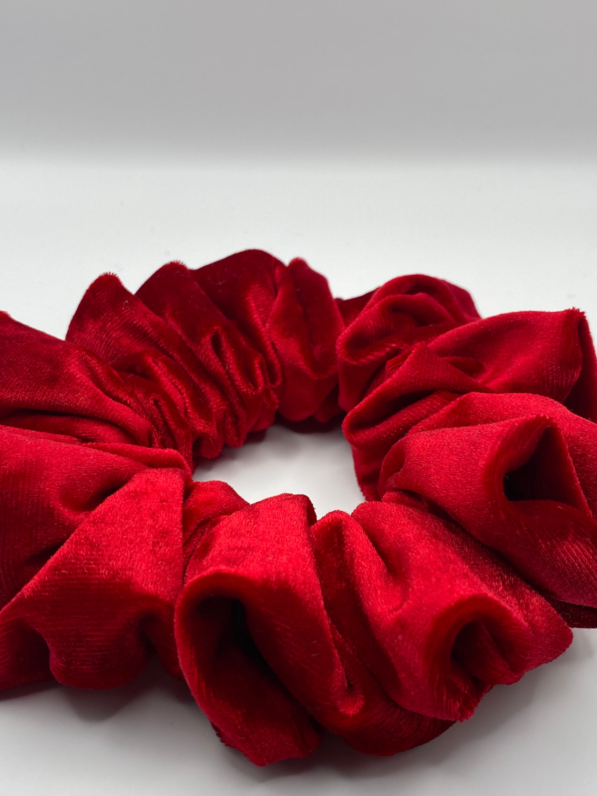 Red scrunchie on a white background